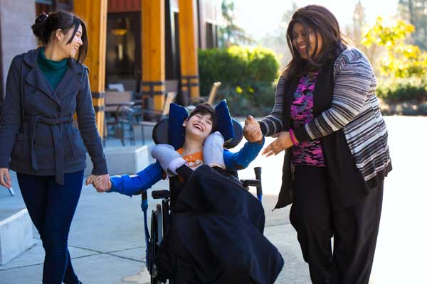 Person in wheel chair being helped Person in wheel chair being helped
